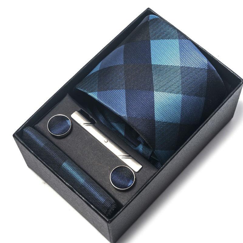 Blue checkered tie set with cufflinks and a tie clip in a black box on a white background