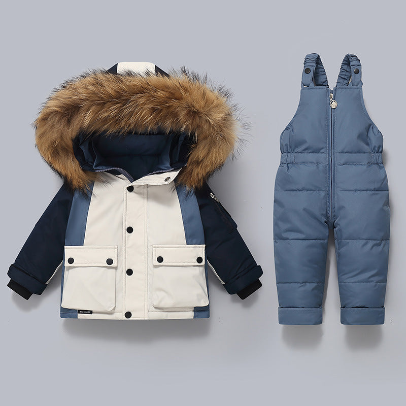 Children's winter jacket with fur hood and blue snow pants on a gray background