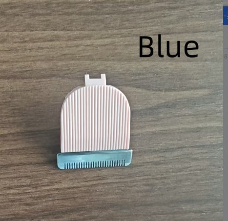 White grooming brush with blue base on a wooden surface, labeled 'Blue'.