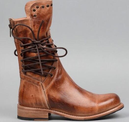 A brown leather lace-up ankle boot with a low block heel, shown in a side profile against a neutral gray background.