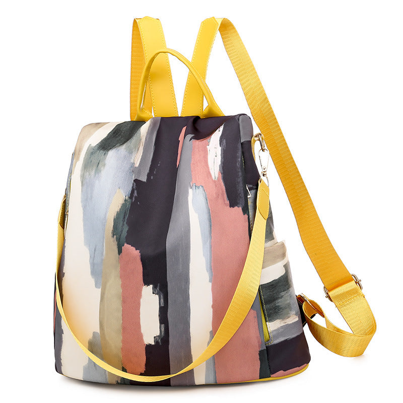 Colorful abstract-patterned backpack with yellow straps on a white background