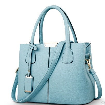 Light blue handbag with a strap on a white background