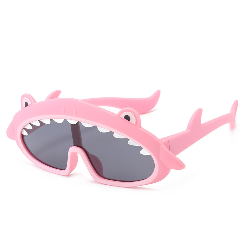 Pink shark-shaped sunglasses on a white background
