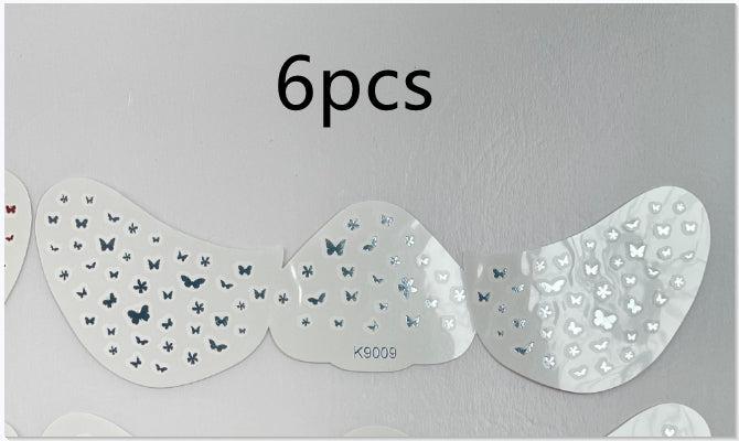 Set of six butterfly-patterned eye stickers on a gray background