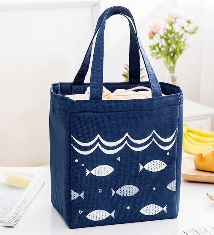 Navy blue tote bag with fish pattern on a white surface