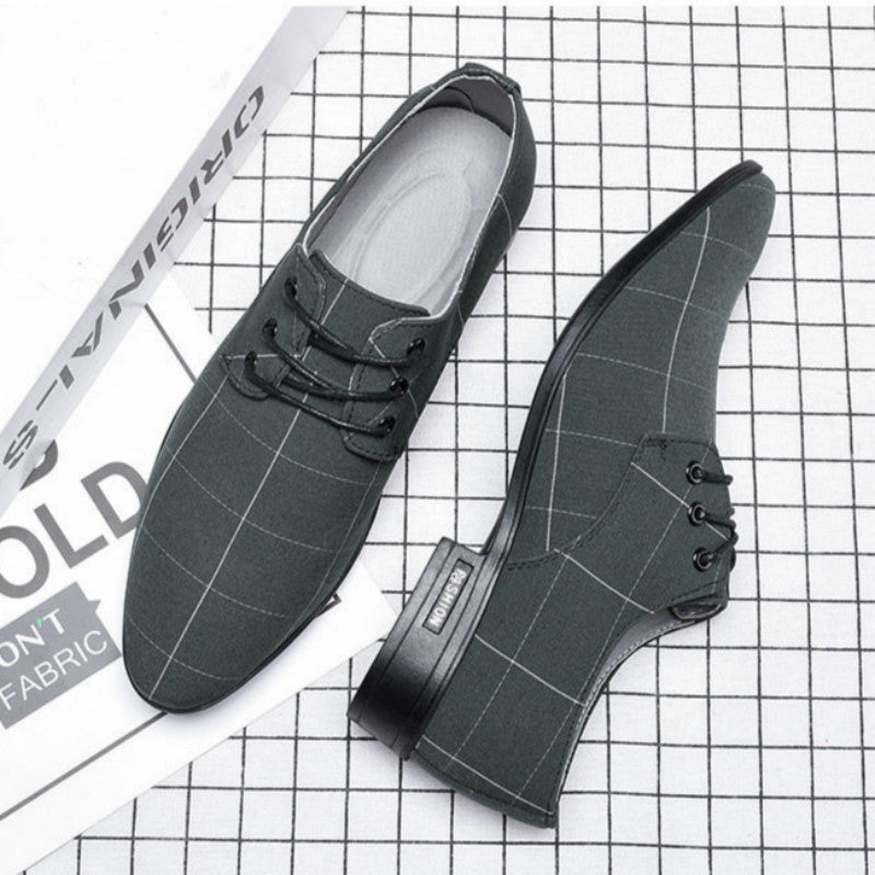Pair of gray checkered shoes on a grid background