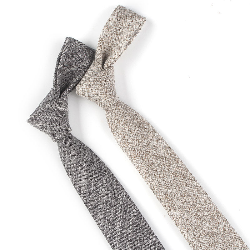 Two textured neckties in gray and beige on a white background