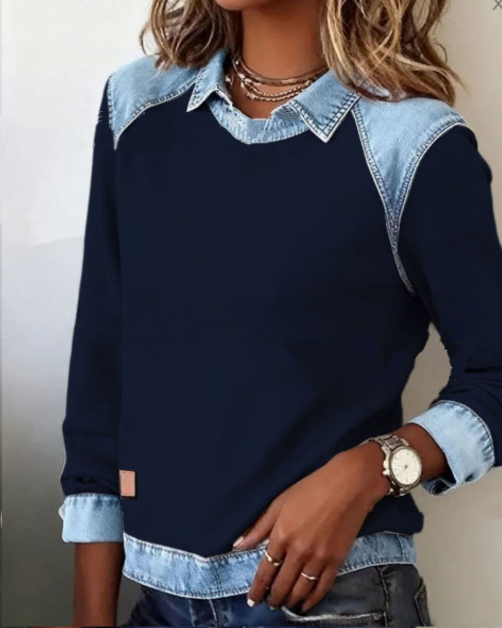 Navy sweater with denim collar and cuffs worn by a person.