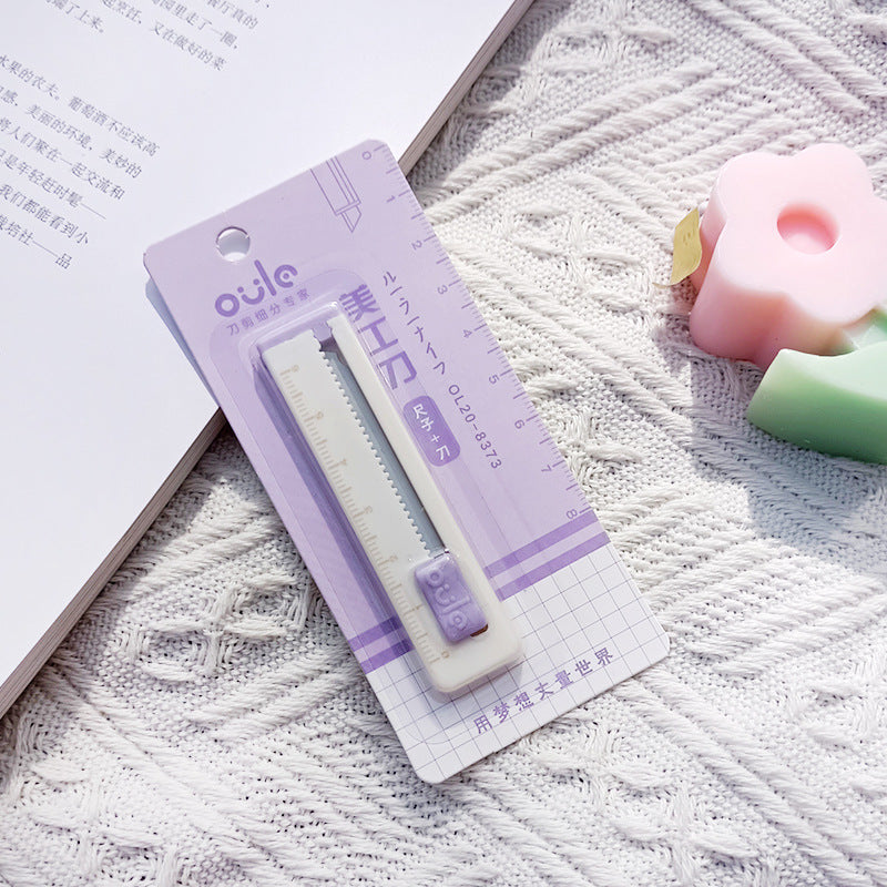 Small ruler with packaging on a textured surface