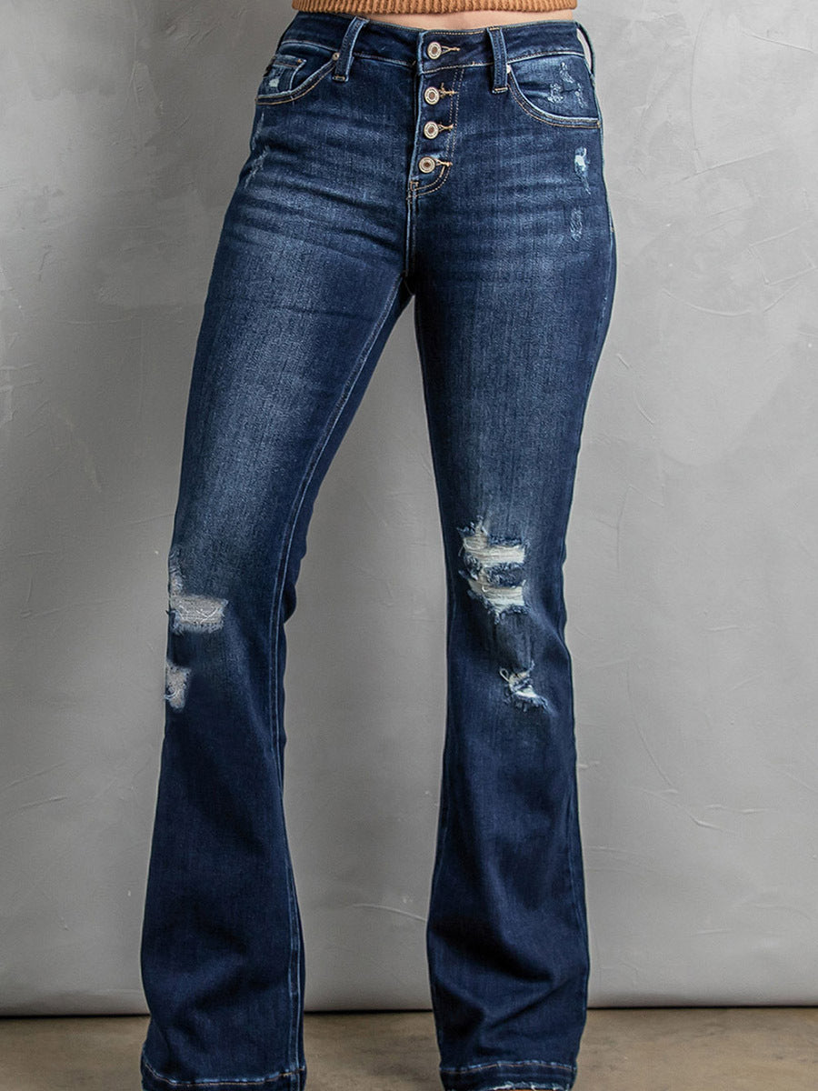Distressed blue jeans on a plain background