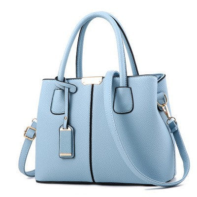 Light blue handbag with a shoulder strap on a white background