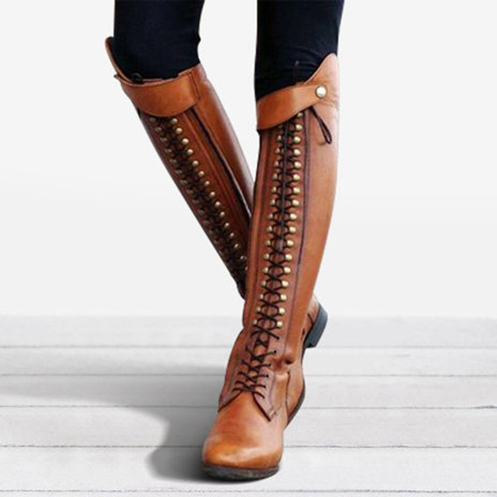 Brown knee-high boots with detailed laces on a light background