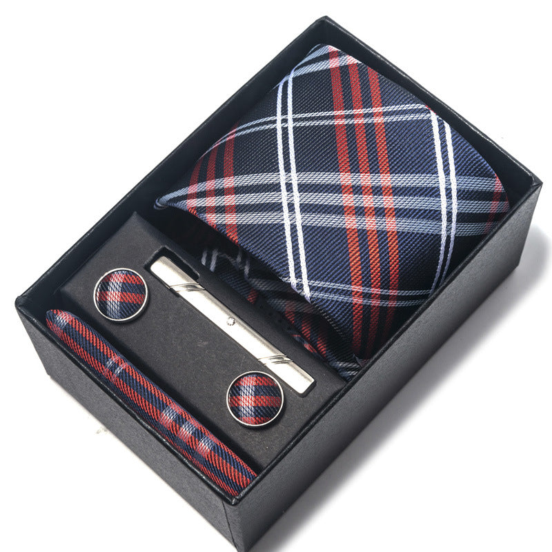 Tie, cufflinks, and tie clip set with plaid pattern in a black box on a white background