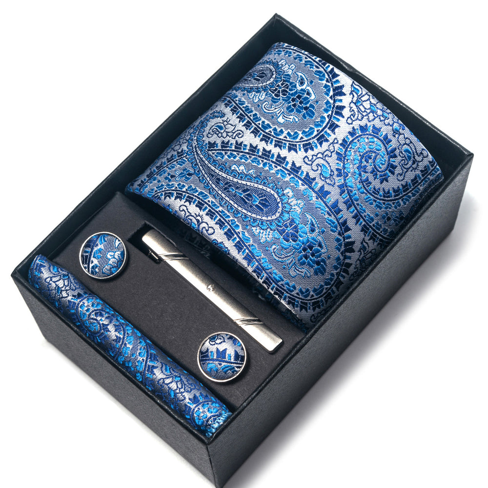Blue paisley tie set with tie clip and cufflinks in a black box on a white background