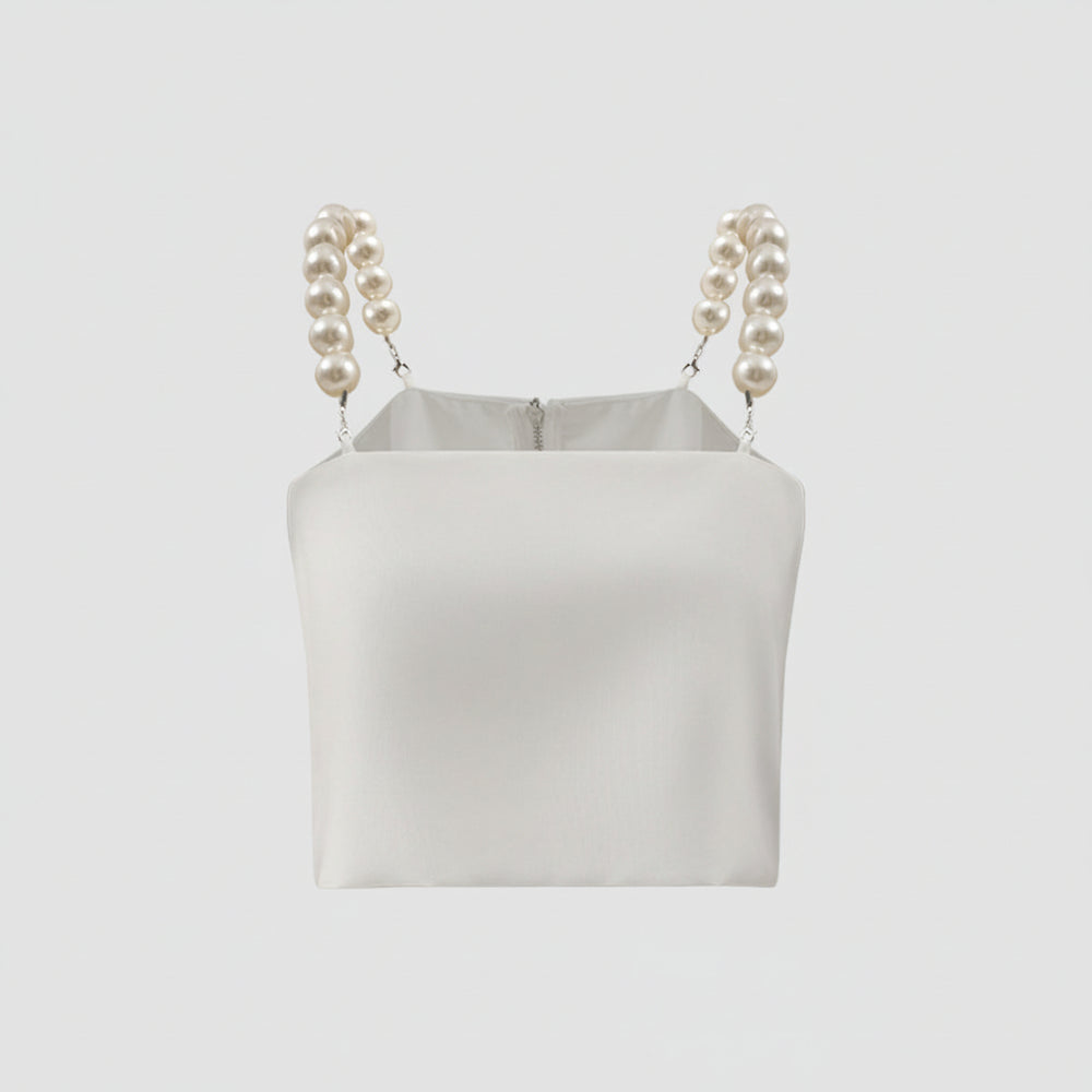 White crop top with pearl straps on a light gray background