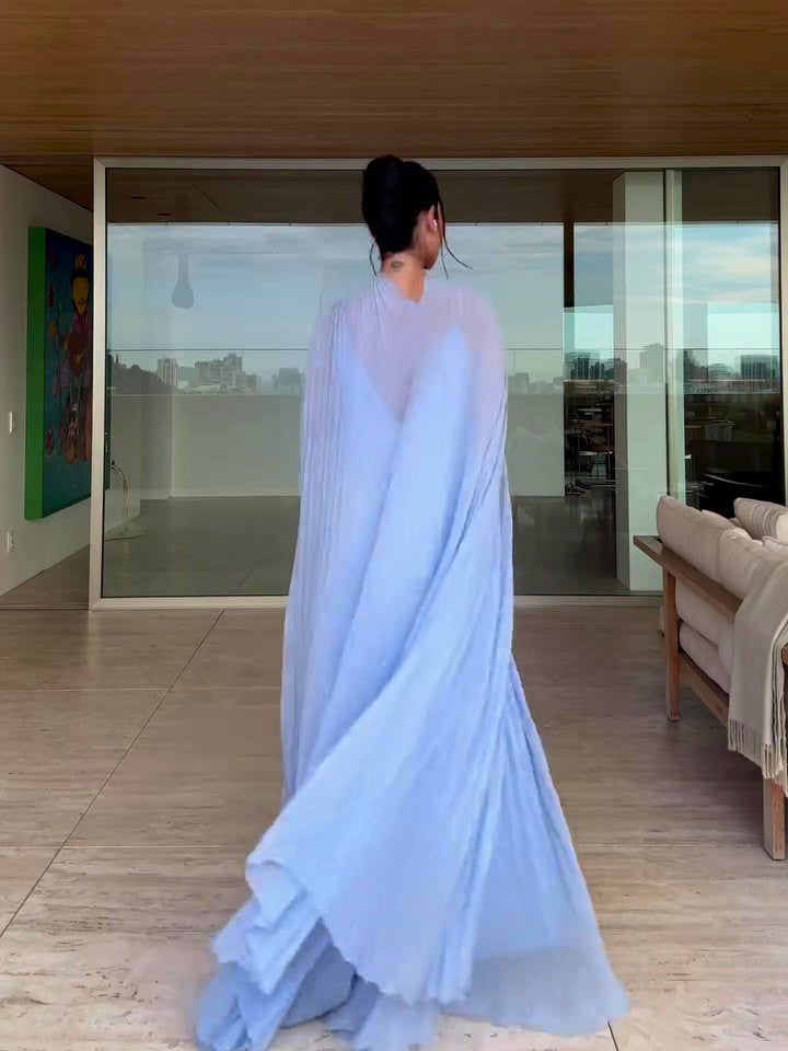 Person wearing a light blue saree in a modern living room.