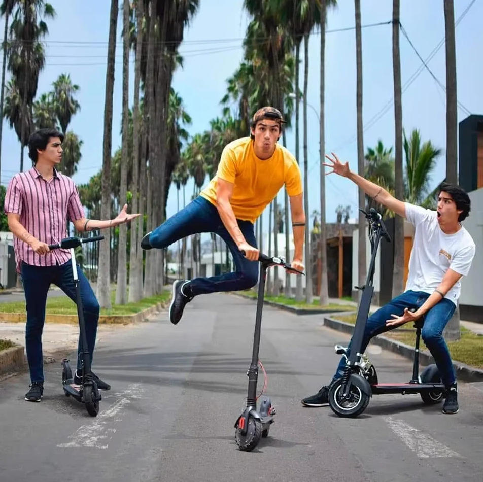 Three young men riding electric scooters on a street with palm trees in the background