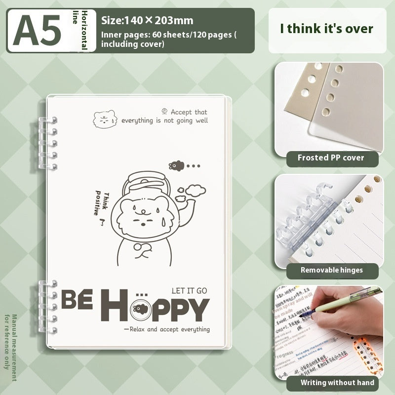 Notebook with a cute illustration and text, showing features like frosted PP cover and removable hinges on a green checkered background.