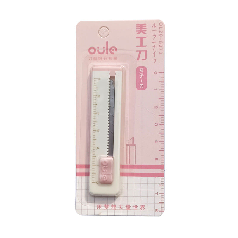 Pink ruler and knife set in packaging with 'oule' branding on a white background