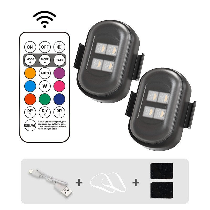 Two LED lights with a remote control on a white background