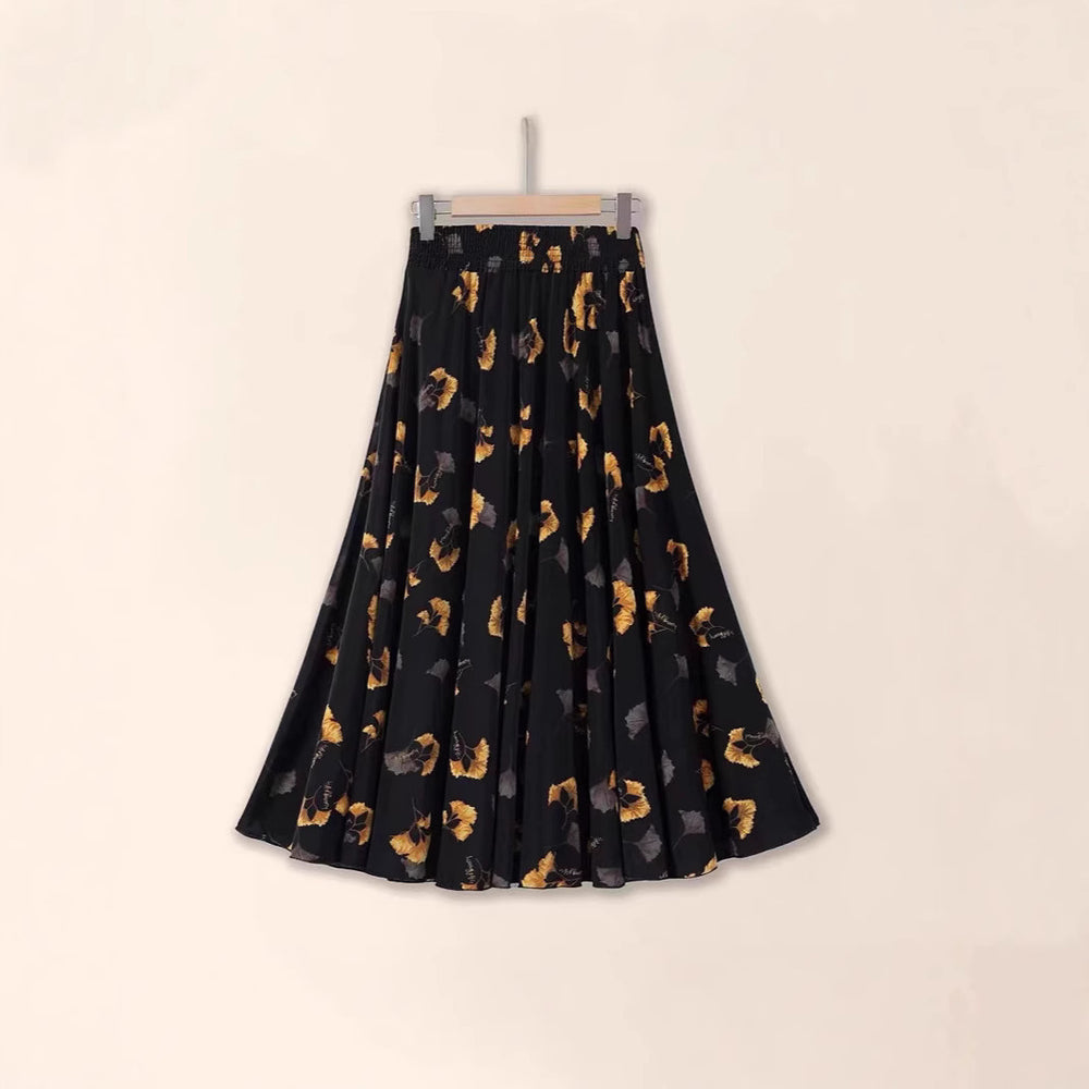 Black skirt with gold animal print on a beige background