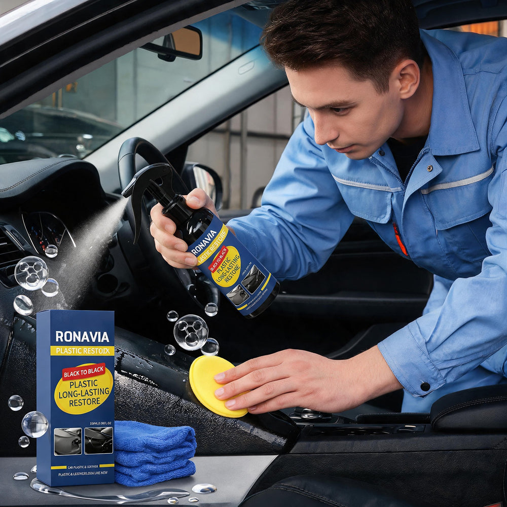 A man in a blue mechanic uniform cleans a car interior with a Ronavia plastic long-lasting restoration spray, using a yellow sponge and blue towels, with the product box shown in the foreground.