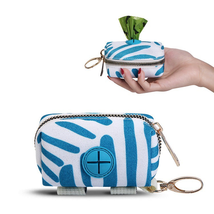 Blue and white patterned pouch with a keychain held by a hand on a white background