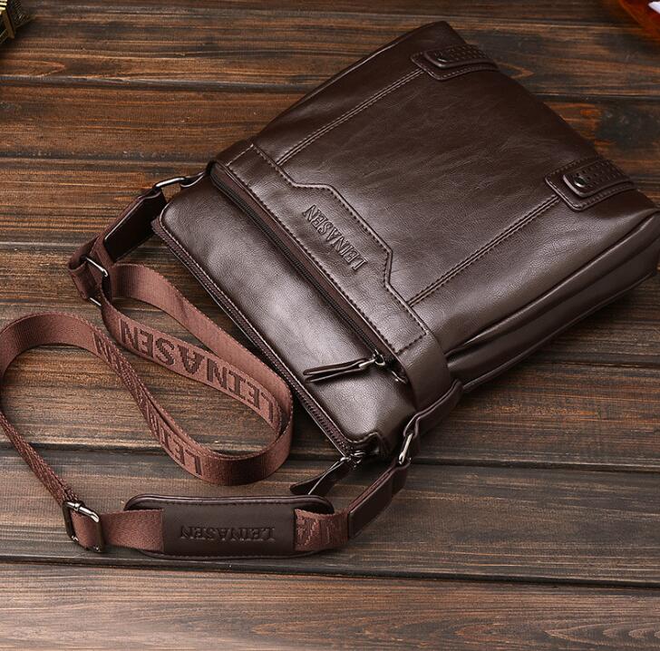 Brown leather bag with visible brand name on a wooden surface