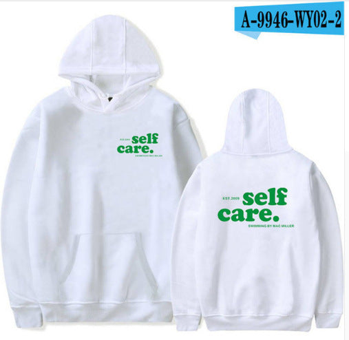 White hoodie with 'self care.' text on front and back, displayed on a white background.