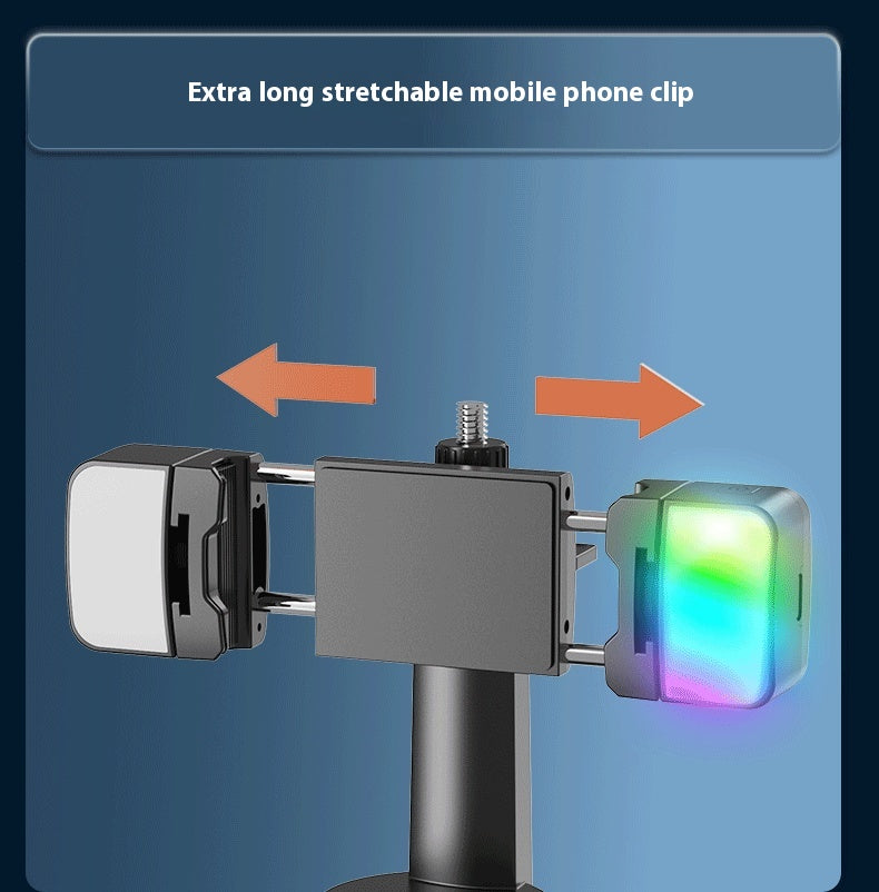 Extra long stretchable mobile phone clip shown on a blue gradient background with orange arrows indicating adjustability. The clip has a dark gray central body, a black mounting post, and two rectangular ends: one plain white/silver and one glowing with multicolor LED light.