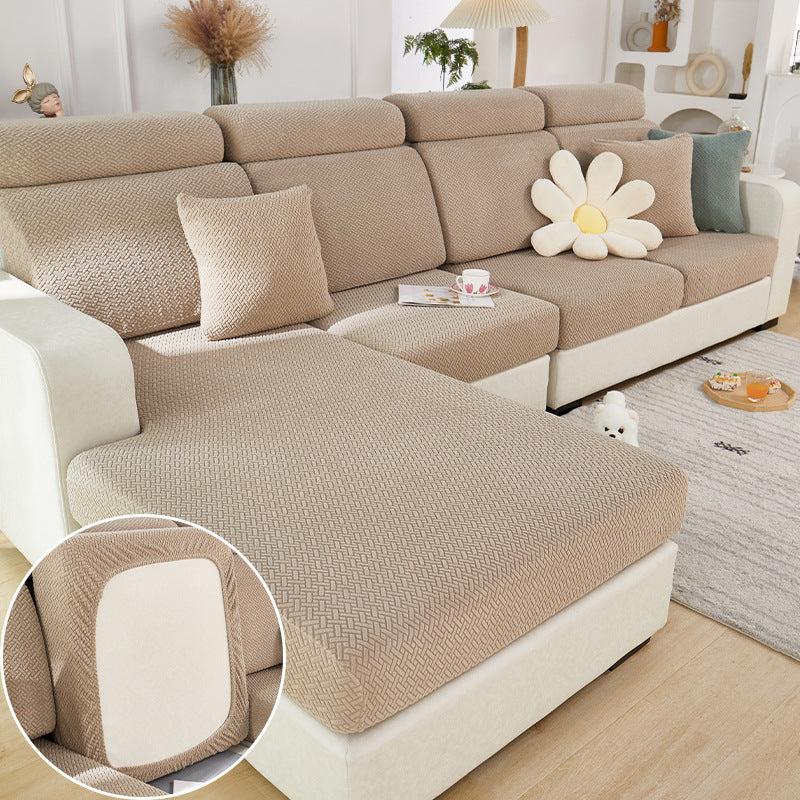 Beige sectional sofa with textured cover and decorative pillows in a living room setting.
