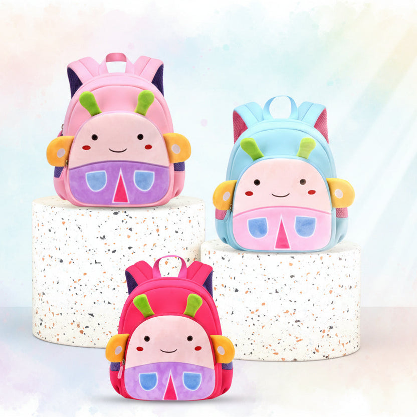 Three colorful children's backpacks with cartoon faces on a turquoise background