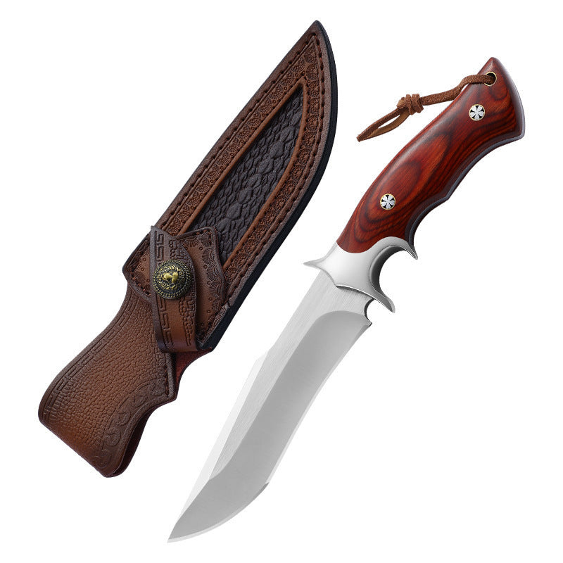 Knife with wooden handle and leather sheath on a white background
