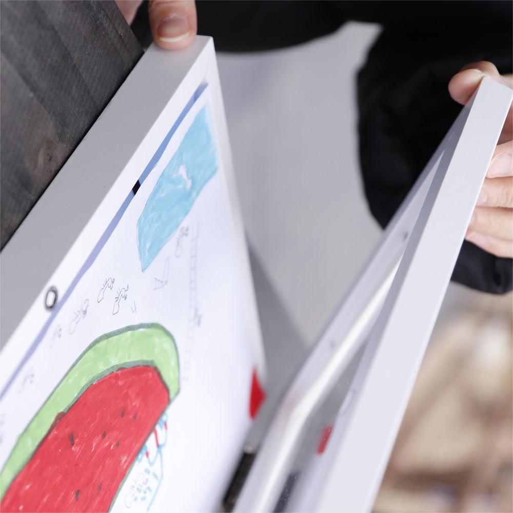 Person holding a book with a watermelon illustration on a blurred background