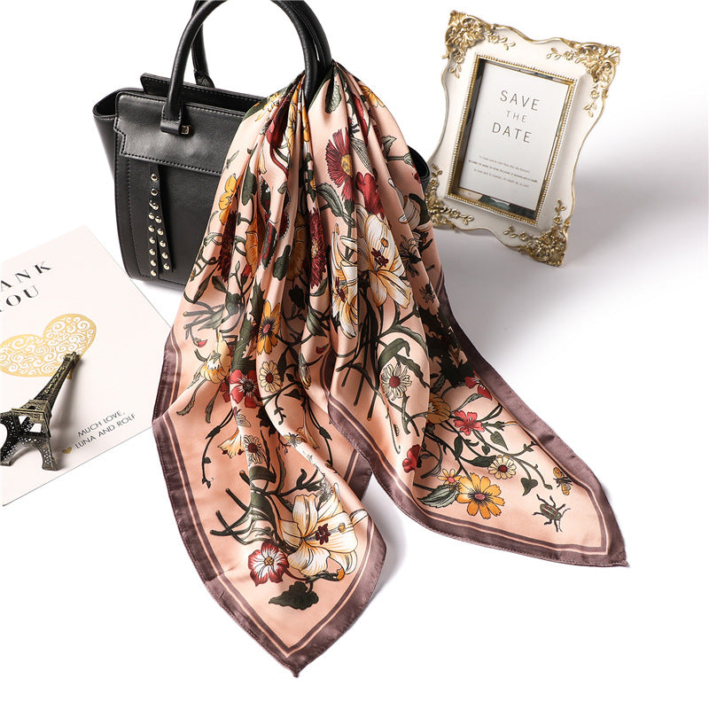 Floral patterned scarf with a black handbag and 'Save the Date' frame on a white background