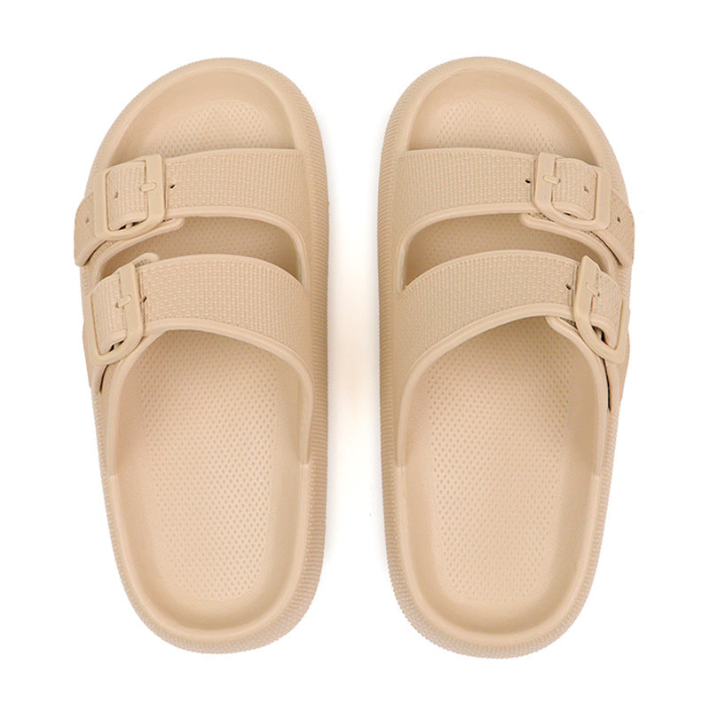 Pair of beige sandals with buckle straps on a white background
