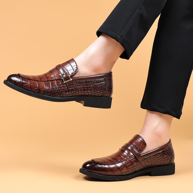 Brown leather shoes worn with black pants on a beige background