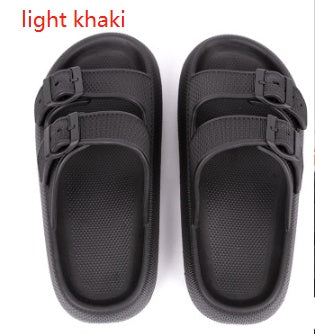Pair of light khaki sandals with black straps on a white background