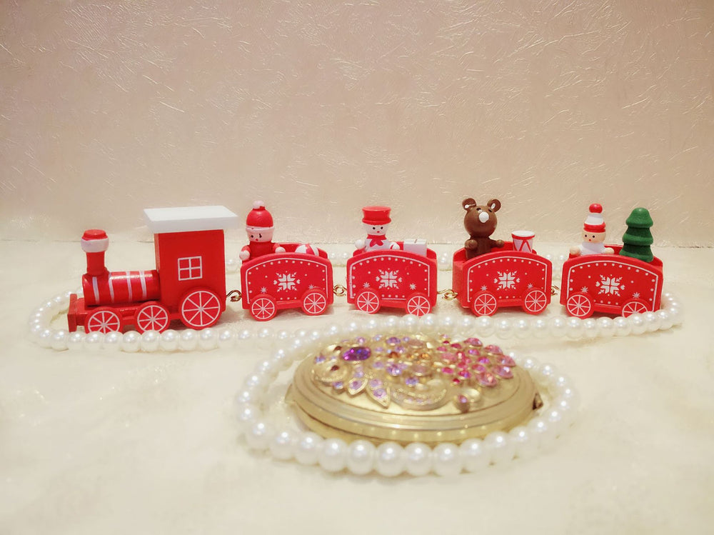 Decorative train set with small figures on a beige background