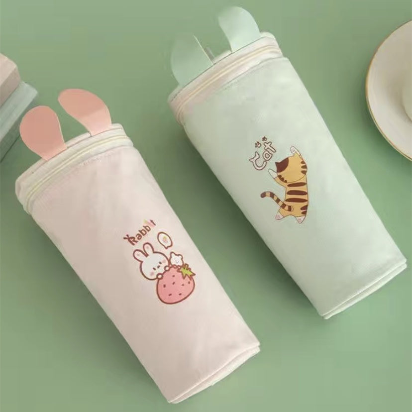 Two cute pouches with animal illustrations on a green background