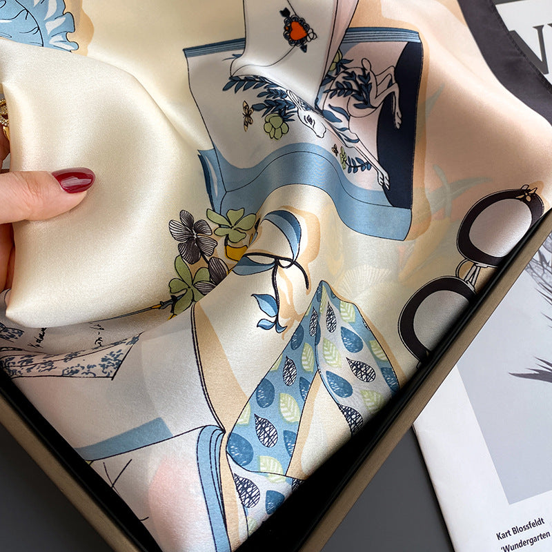 Silk scarf with artistic design held over a magazine