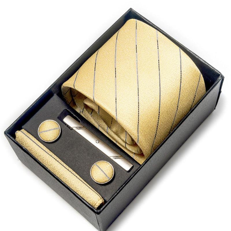 Gold striped tie set with tie clip and cufflinks in a box on a white background