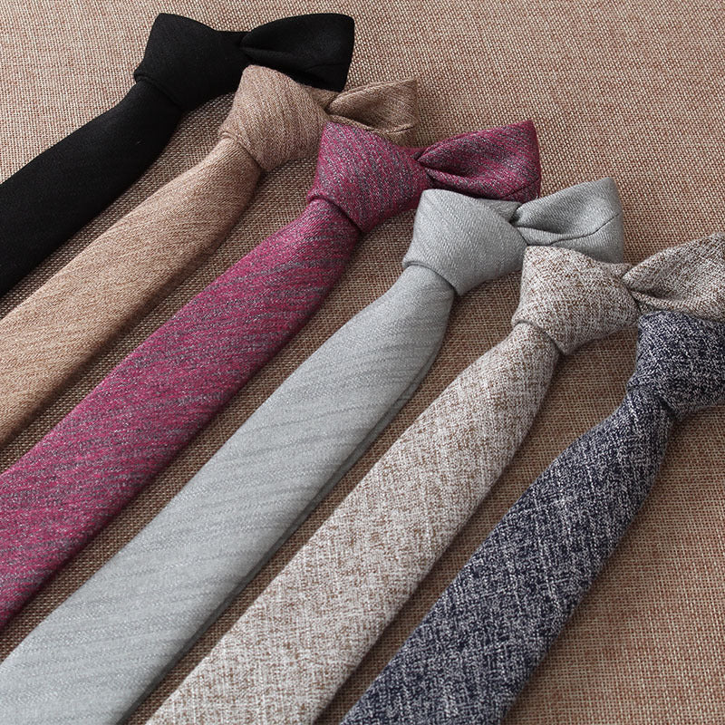 Set of various colored ties arranged on a textured surface