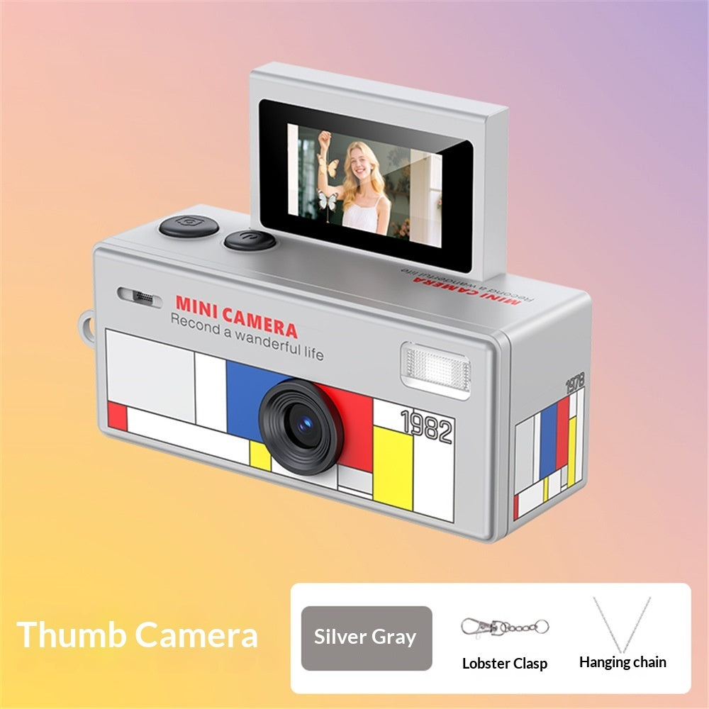 Silver gray mini camera with colorful design on a gradient background