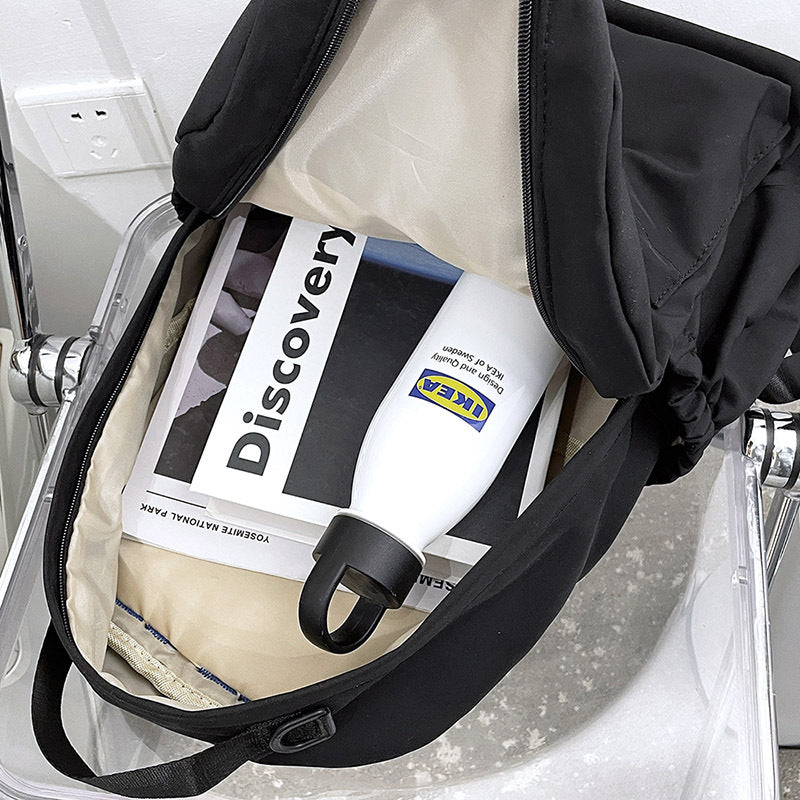 Baby bottle with IKEA logo inside a stroller