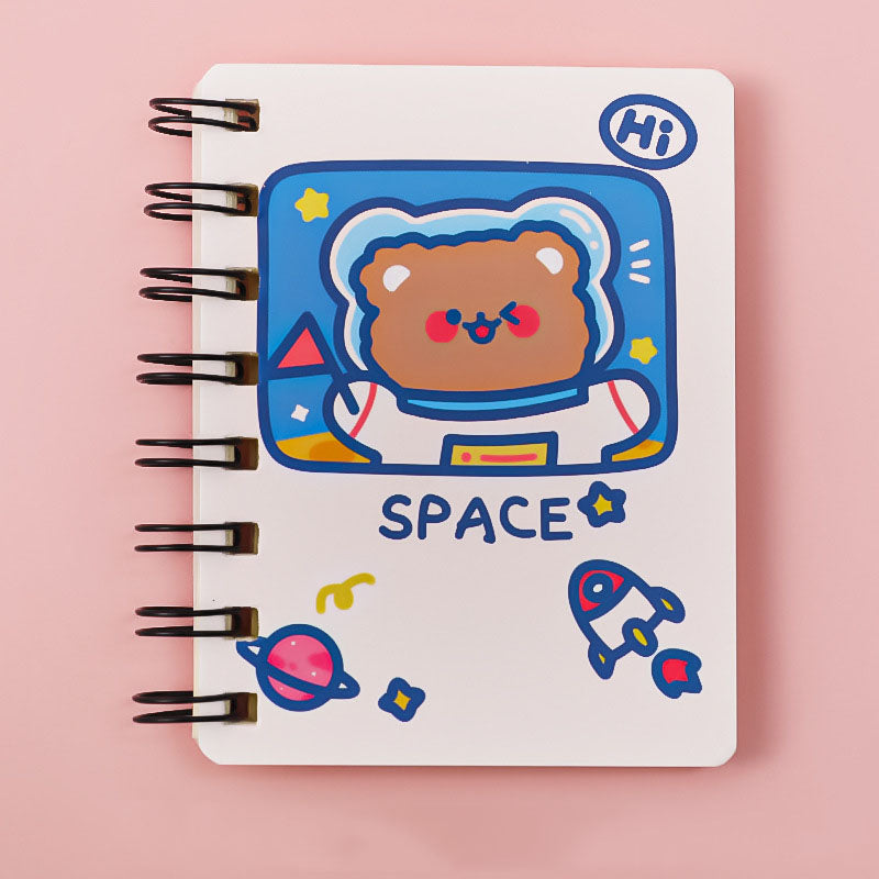 Notebook with a cute bear astronaut illustration on a pink background