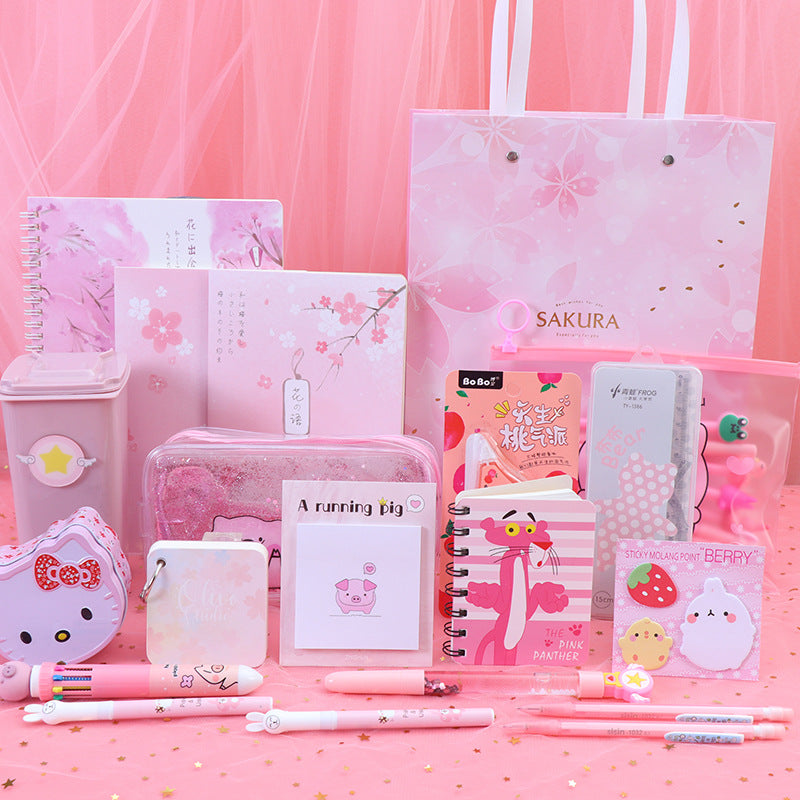 Collection of pink stationery items on a pink background