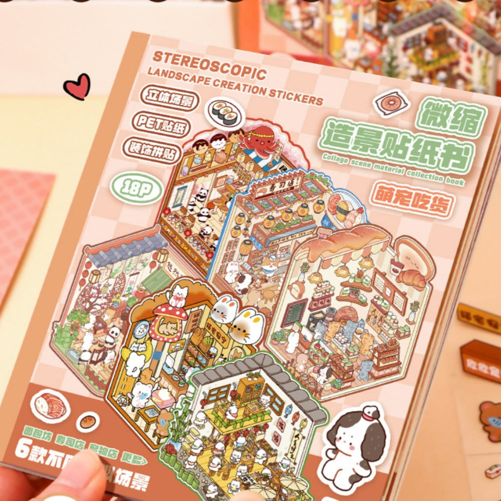 A hand holds a pink-covered sticker book titled 'STEREOSCOPIC LANDSCAPE CREATION STICKERS' with colorful illustrated collage scenes on the cover. The book appears to be the product being sold, photographed in a styled tabletop setting with small decorative props.