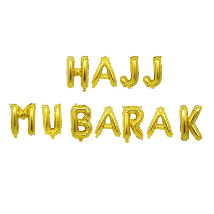 Gold foil balloon letters spelling 'HAJJ MUBARAK' arranged in two lines on a plain white background.