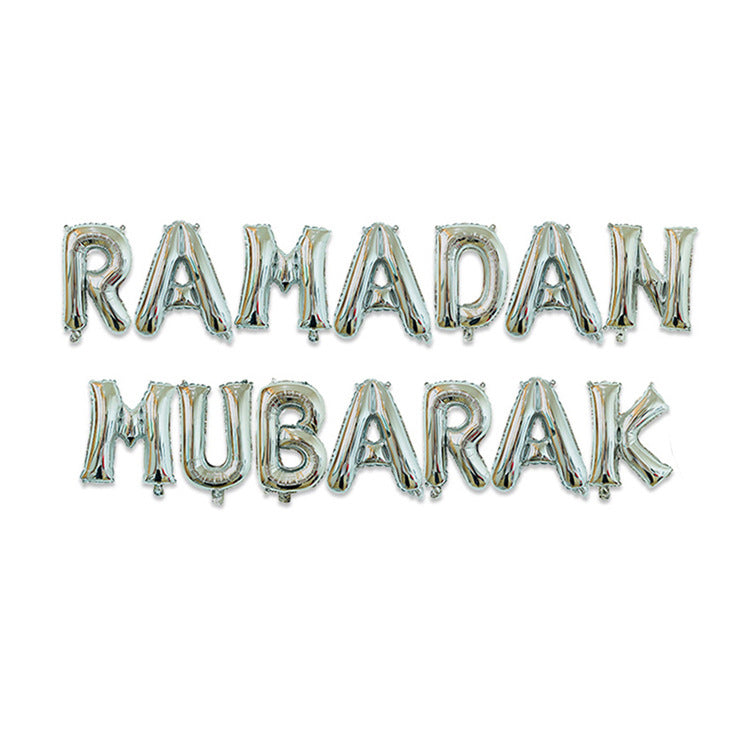 Silver foil balloon letters spelling out 'RAMADAN MUBARAK' in two lines on a plain white background.